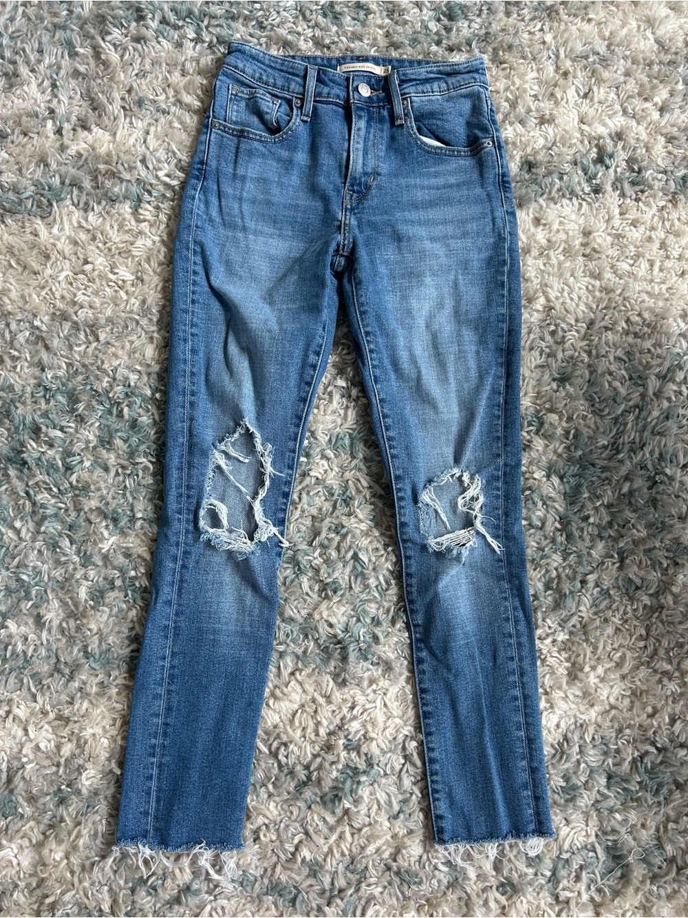 Levi’s Premium 721 high-rise skinny jeans features distressed rips